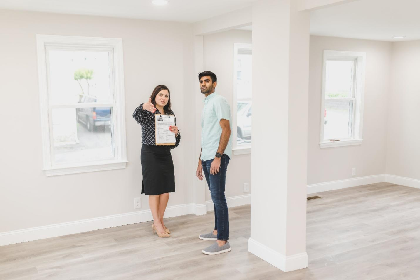 Realtor showing client a house for sale